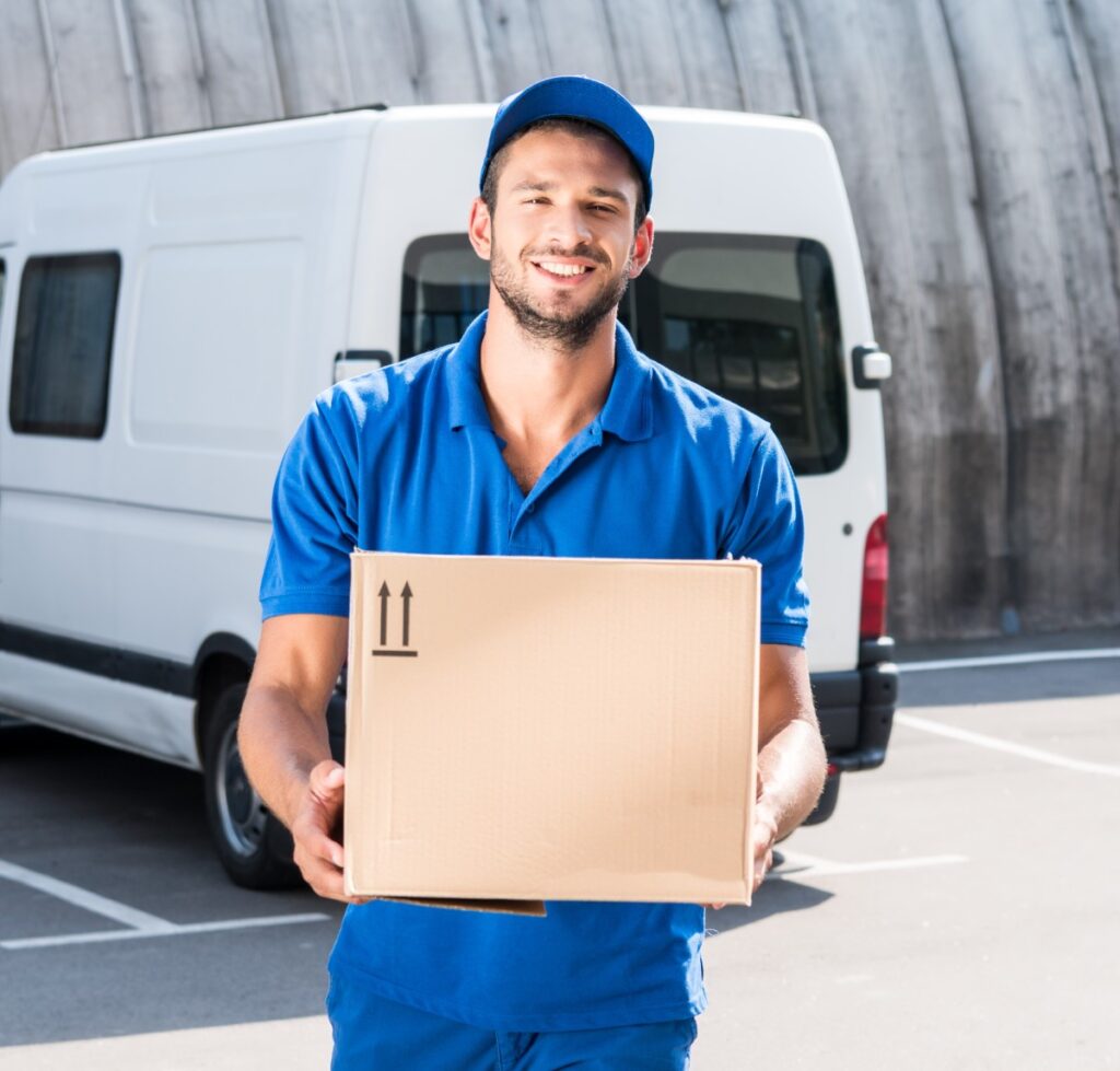 smiling delivery man carrying cardboard box 2024 11 19 00 46 28 utc.jpg